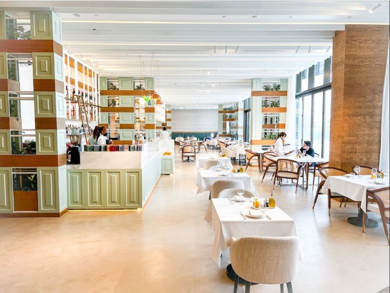 Hyatt Centric Dubai ground floor restaurant with timber and mint joinery shelving towers